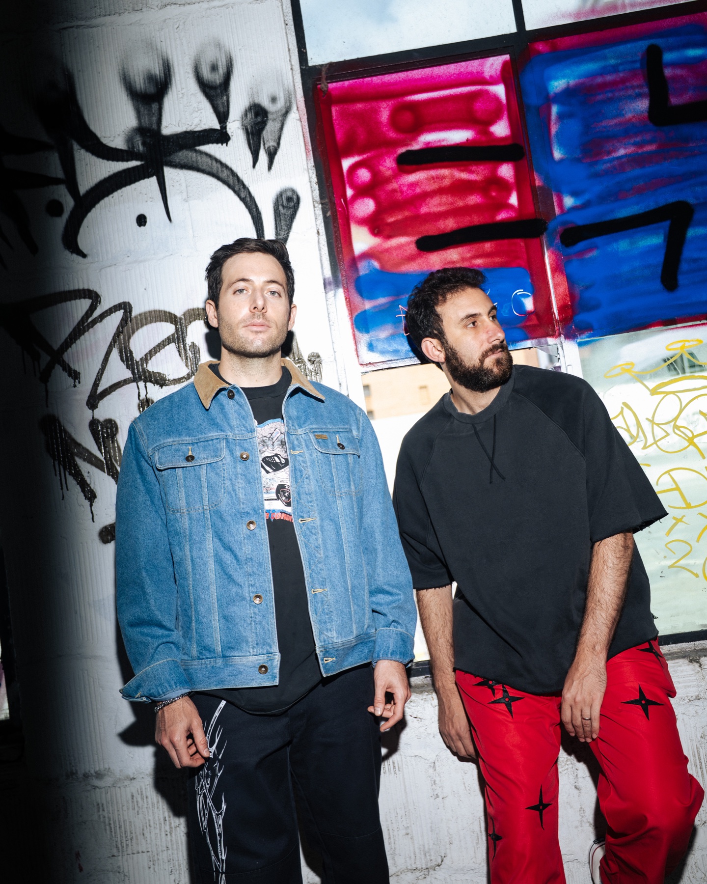 Two Friends photographed on a graffiti-covered fire escape